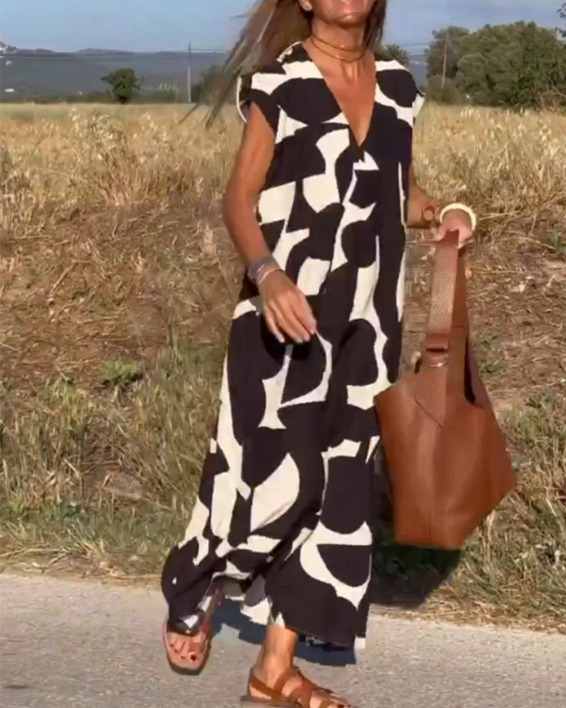 Woman walking in a relaxed abstract print dress, highlighting its effortless and casual style.
