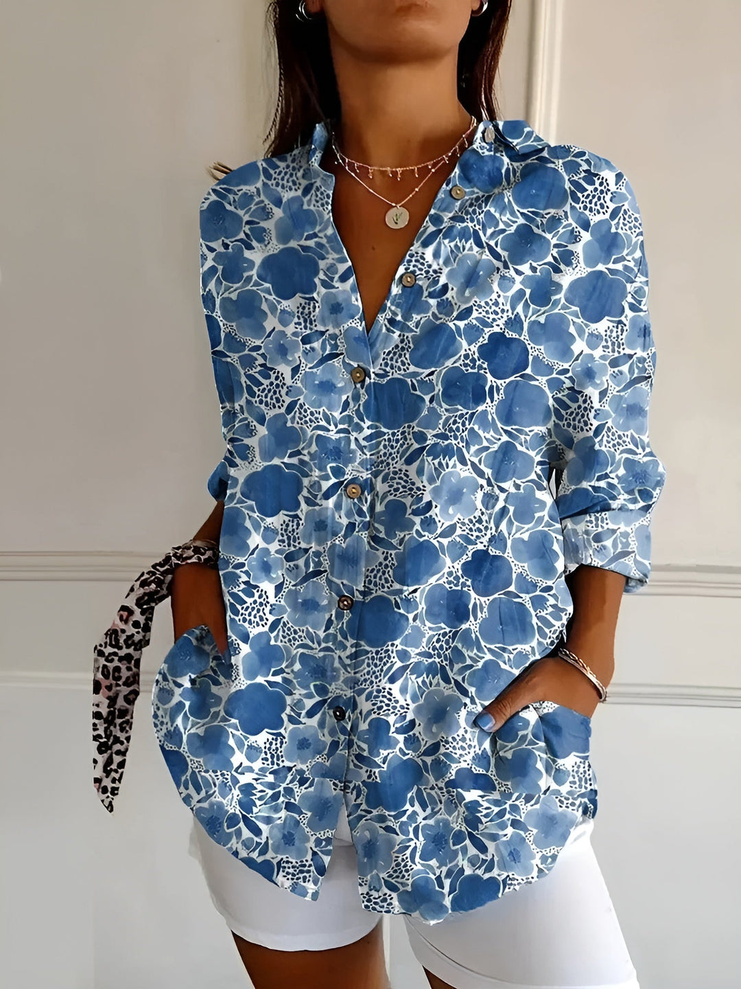 Fashionable women's button-down blouse, comfortable relaxed fit top for work or casual outings.
