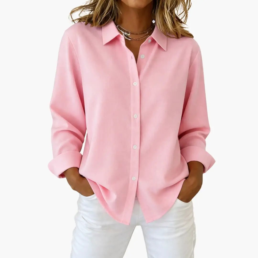 Detail of collared women's button up shirt, long sleeve, highlighting buttons and relaxed cuffs.