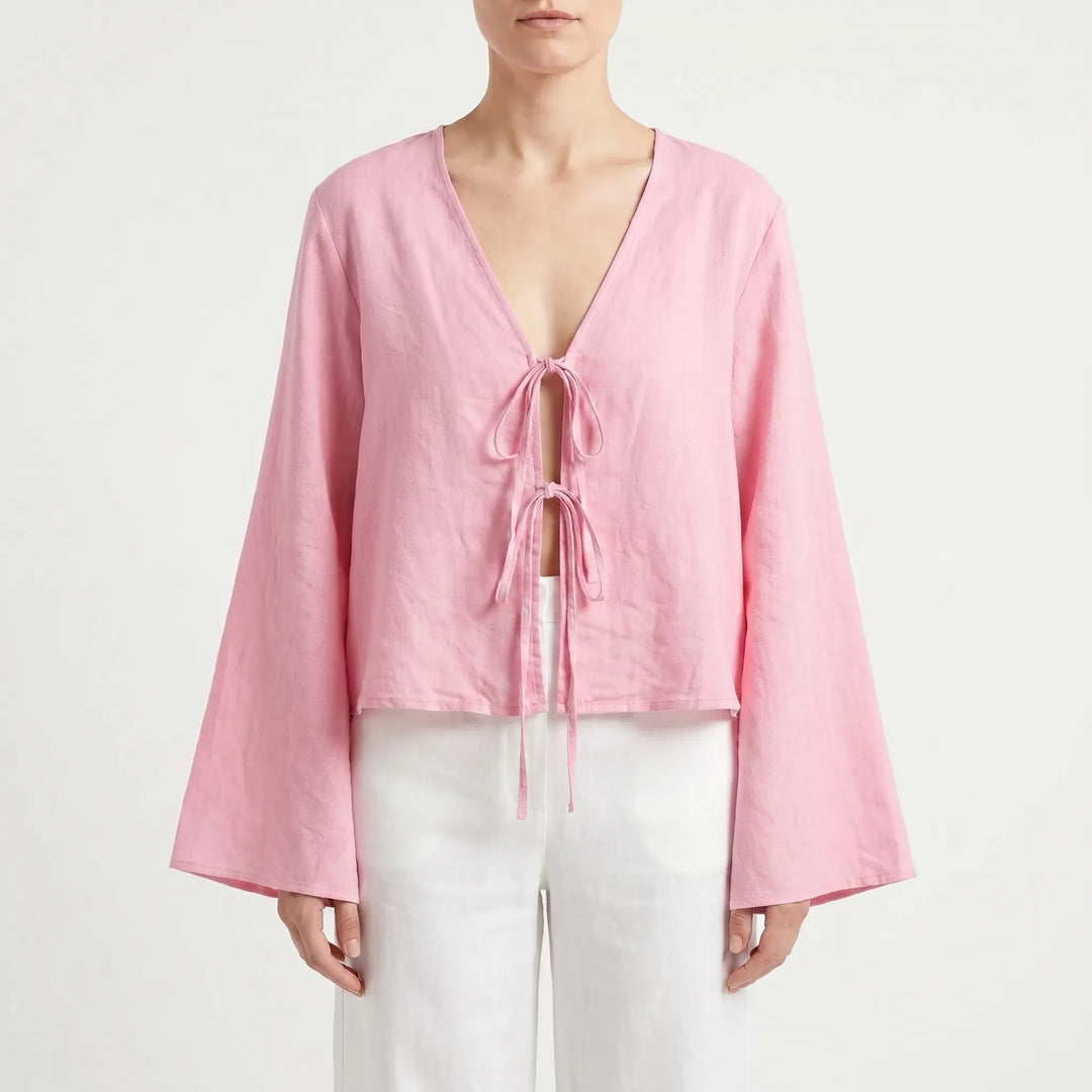 White relaxed fit front-tie blouse with V-neck and flared sleeves. Chic summer top for weekend wear.