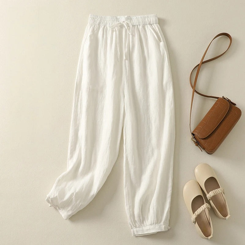 Woman in flowy relaxed fit harem pants, perfect for casual outings, travel, and summer fashion.