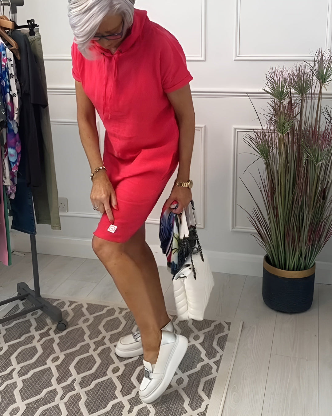 Stylish women's relaxed fit hoodie midi dress, mid-length, featuring a practical adjustable hood.