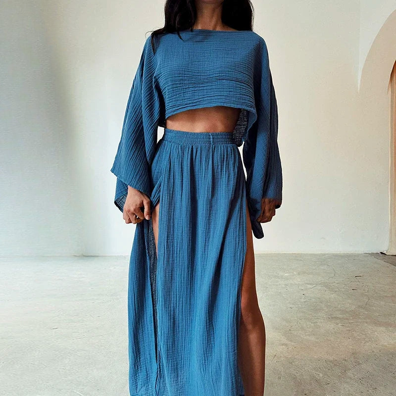 Stylish women's linen blend two-piece set, a chic summer outfit with a relaxed cropped top & a flowing slit skirt.