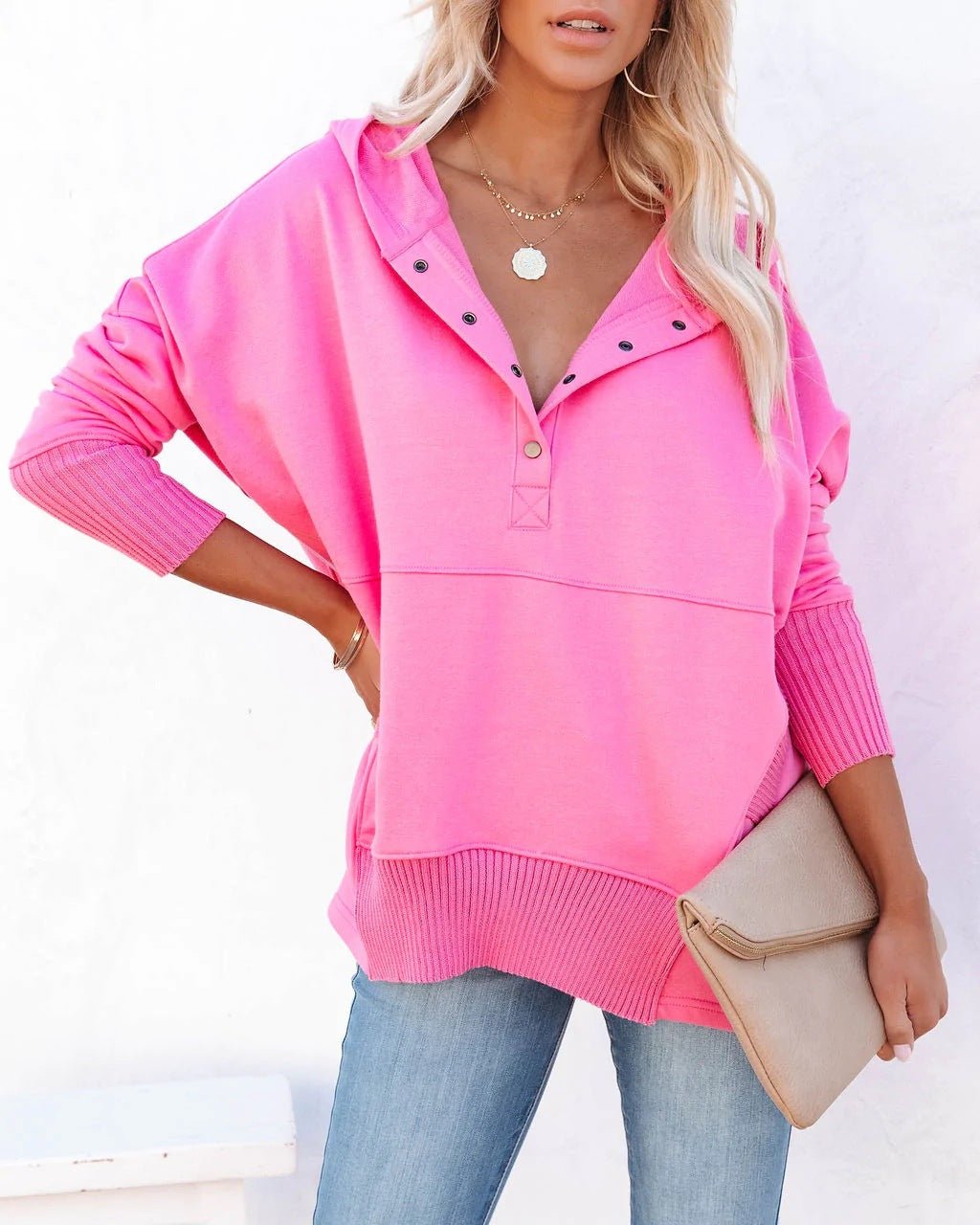 Detail of women's longline tunic hoodie. Relaxed fit pullover sweatshirt highlighting texture.