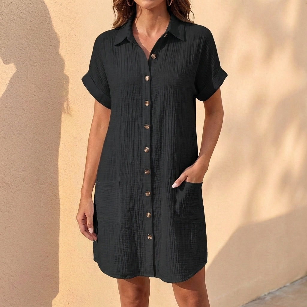Button-front women's midi shirt dress with cuffed short sleeves & relaxed fit. Stylish collared casual dress.