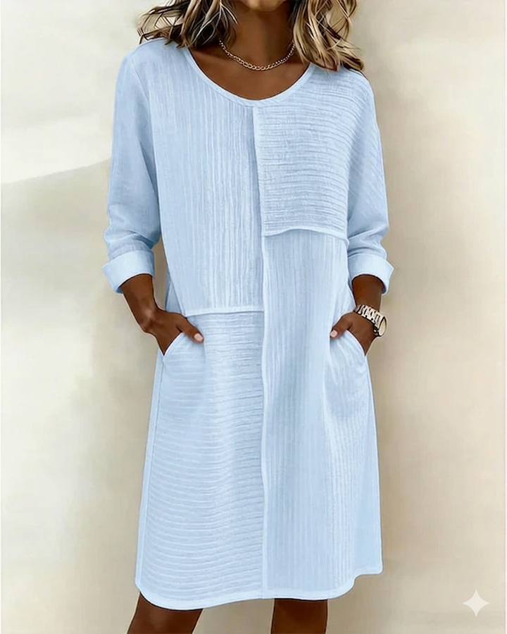 Stylish women's relaxed fit shift dress featuring three-quarter sleeves and convenient pockets. Casual yet chic.