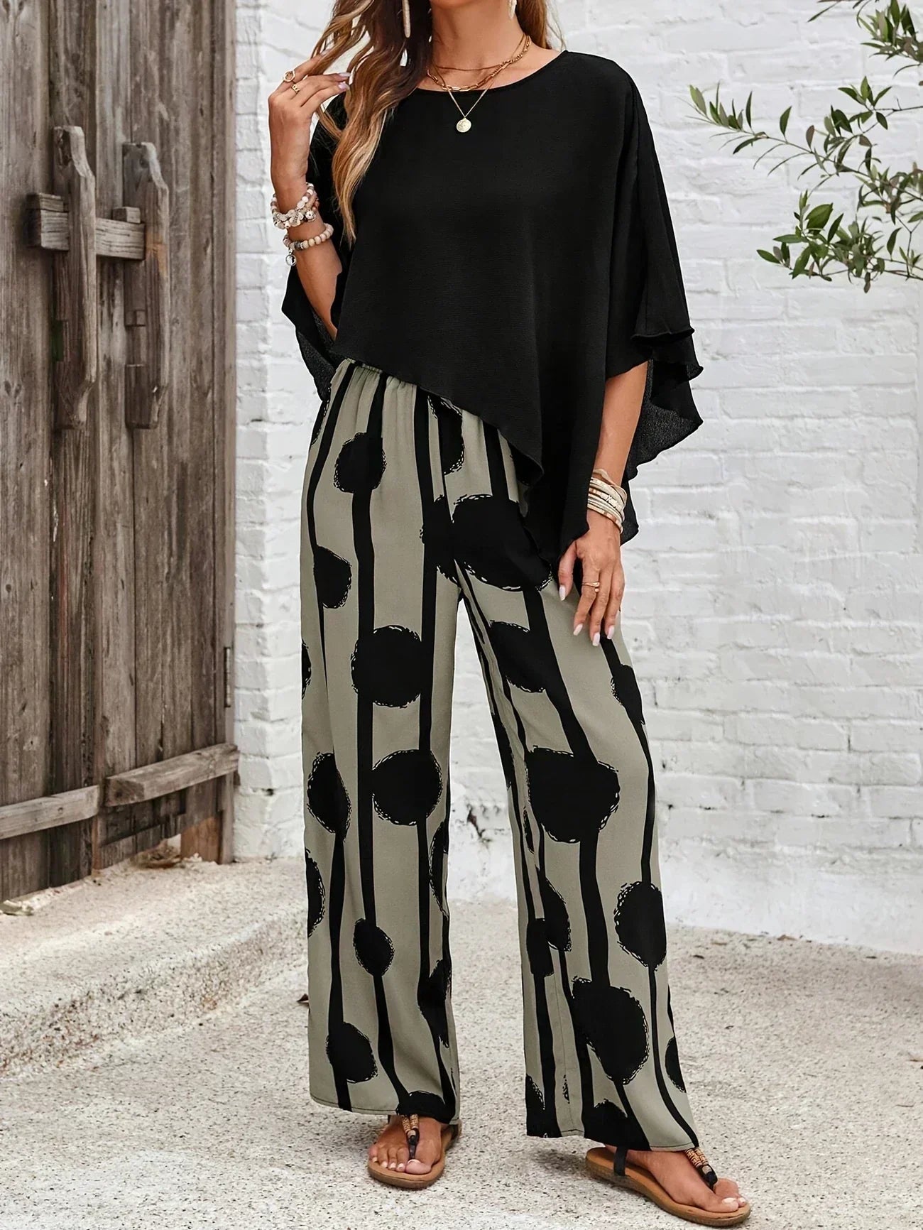 Comfortable women's summer set: relaxed fit top and wide-leg pants with unique abstract design.