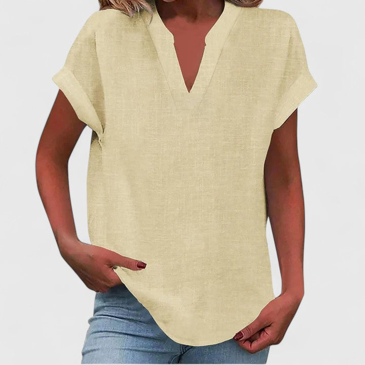 Comfortable women's V-neck blouse with cap sleeves and a flattering curved hem, perfect for comfort.