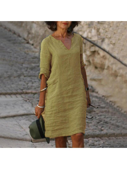 Chic women's V-neck midi dress, relaxed fit, short sleeve, pockets. Comfortable for casual everyday wear.