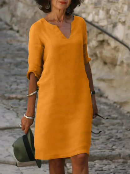 Everyday women's relaxed V-neck dress, comfortable midi length with short sleeves and convenient pockets.