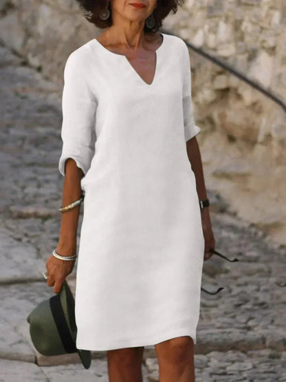 Casual women's relaxed fit V-neck midi dress with short sleeves and pockets, ideal for summer fashion.