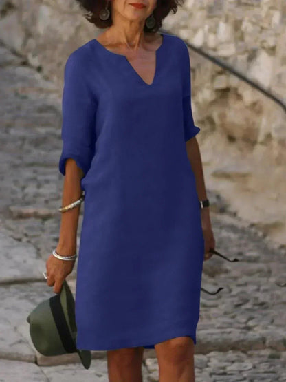 Classic women's V-neck everyday dress, relaxed fit, midi length, short sleeve with handy pockets.