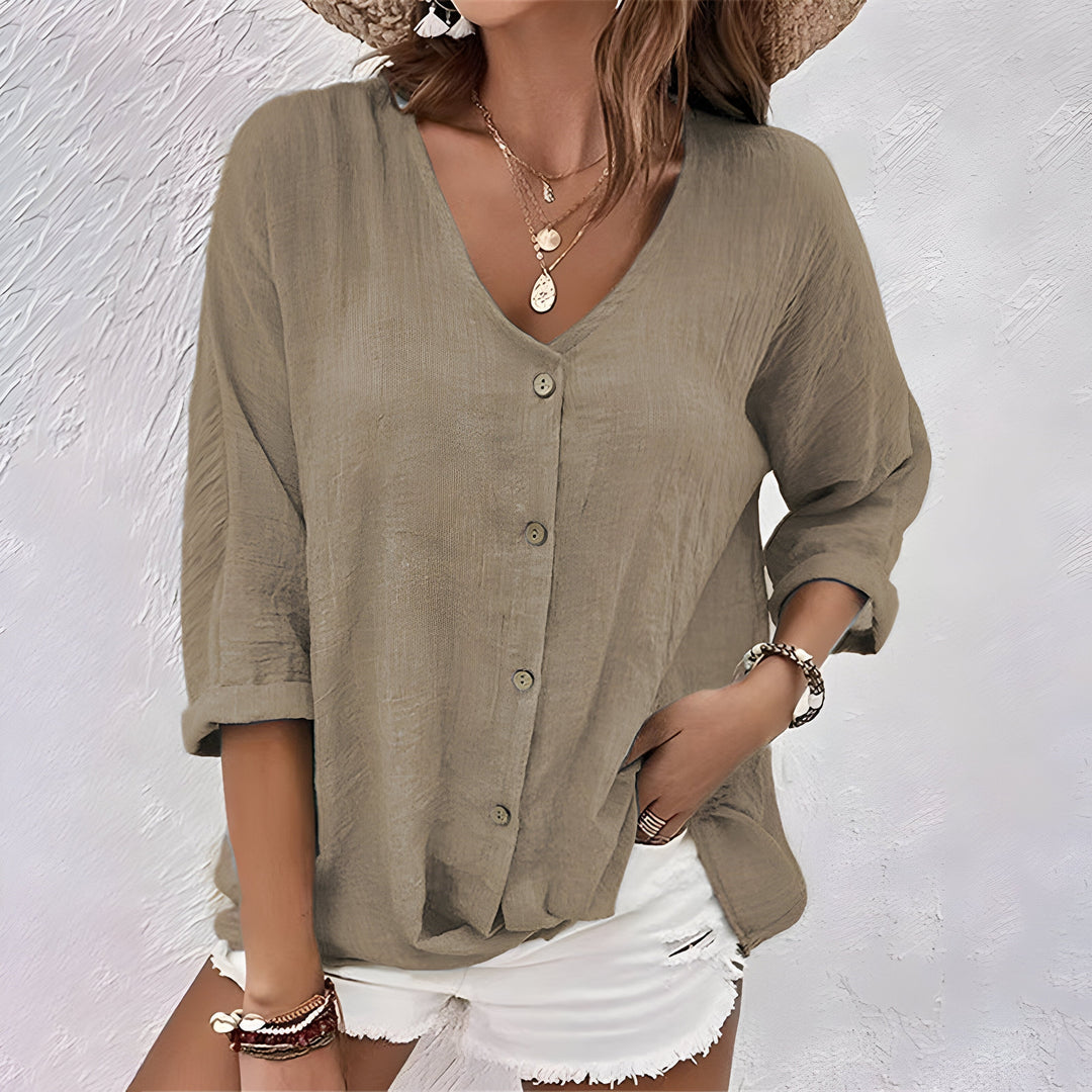 Fashionable women's relaxed V-neck roll sleeve blouse with buttons, a comfortable and versatile top for any season.