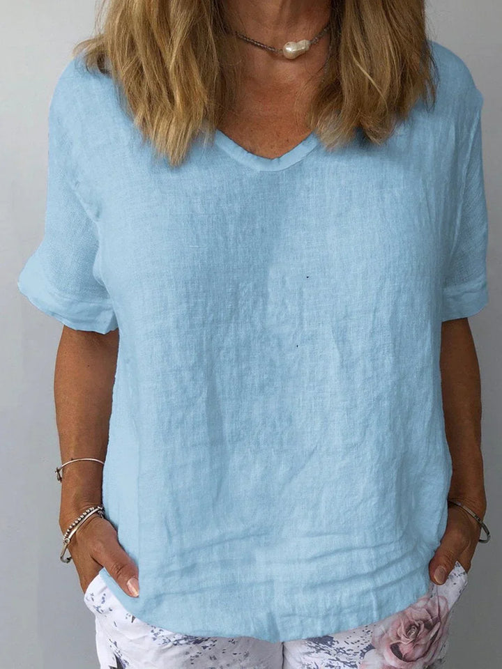 Comfortable women's V-neck short sleeve blouse. Relaxed fit, minimalist design for everyday wear.