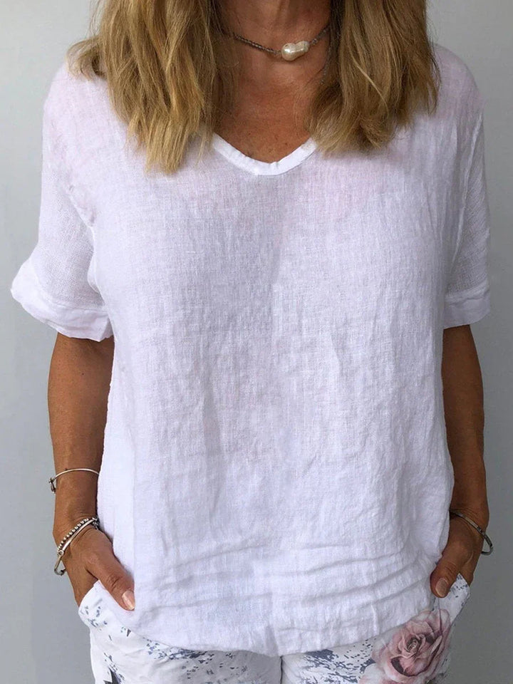 Elegant women's short sleeve V-neck blouse with a relaxed fit. Stylish and comfortable everyday top.