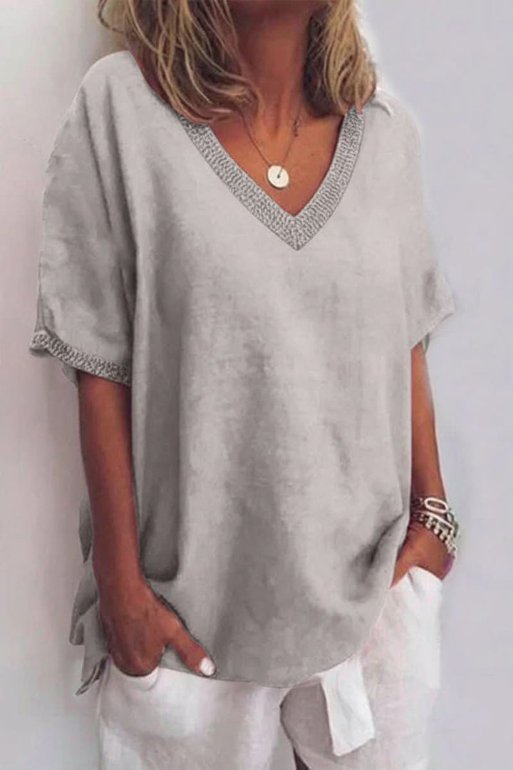 Gray women's relaxed V-neck blouse. Versatile summer top for casual fashion and effortless warm weather style.