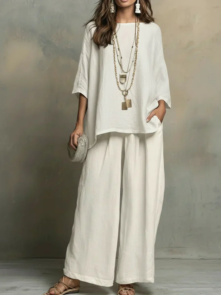 Women's relaxed fit white shirt and wide-leg pants set, perfect for summer casual wear and vacation.