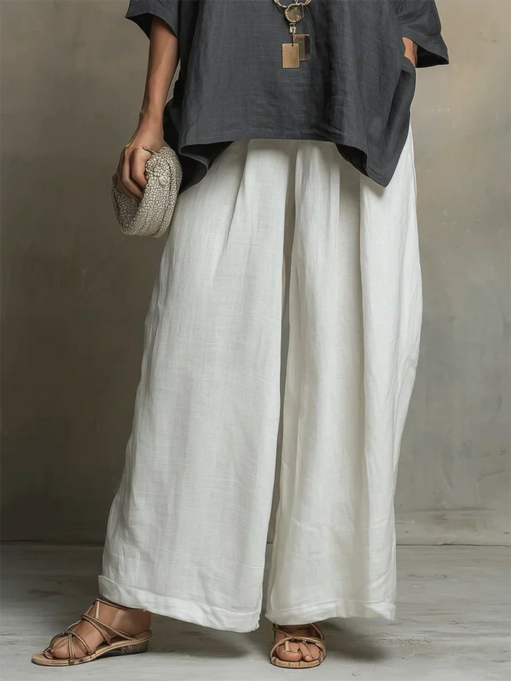 White women's relaxed fit shirt & wide-leg pants set. A stylish, comfortable two-piece for summer and vacation fashion.