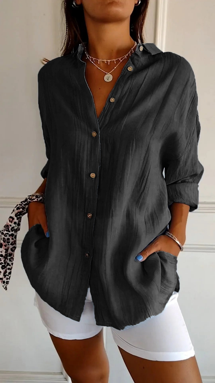 Comfortable women's oversized button-up shirt, long sleeves, relaxed fit for daily wear and style.
