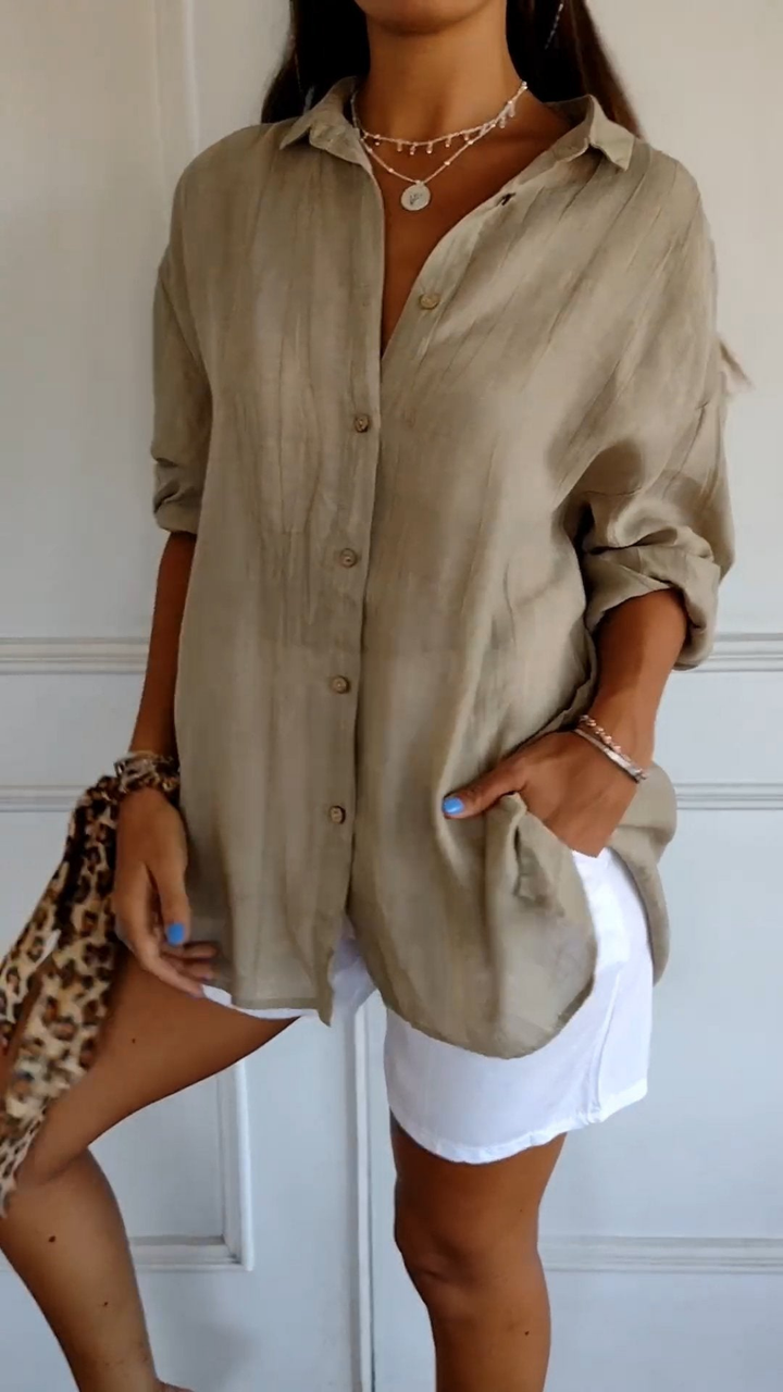 Loose fit women's oversized button-up shirt with long sleeves, comfortable & stylish for daily wear.