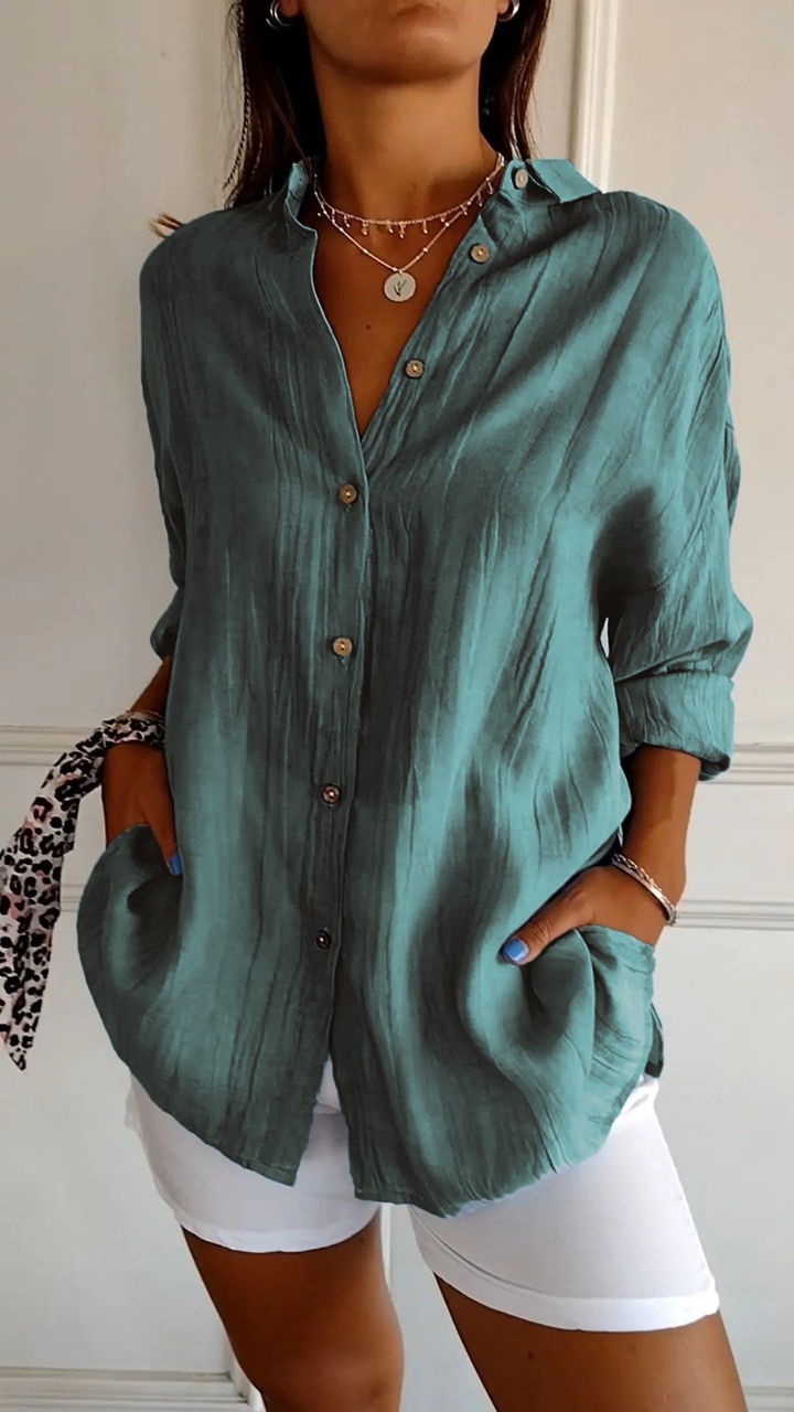 White women's relaxed oversized button-up shirt, long sleeves, a classic versatile everyday top.