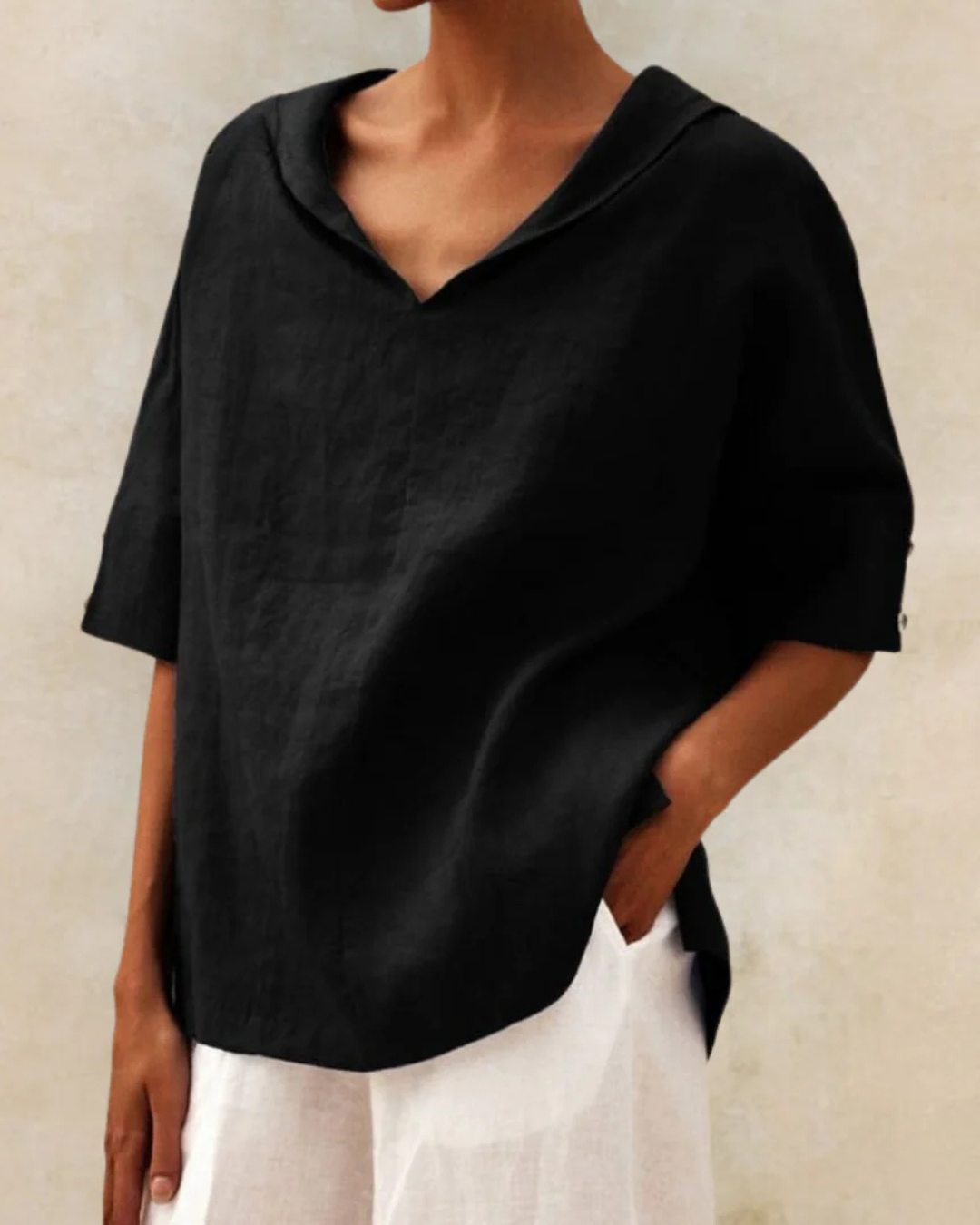 Relaxed fit women's V-neck blouse with short sleeves, great for everyday style and comfortable wear.
