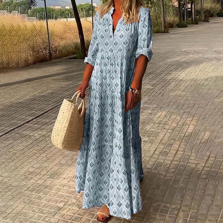 Flowy women's bohemian maxi dress, relaxed V-neck, long roll-up sleeves, vibrant boho print for everyday style.
