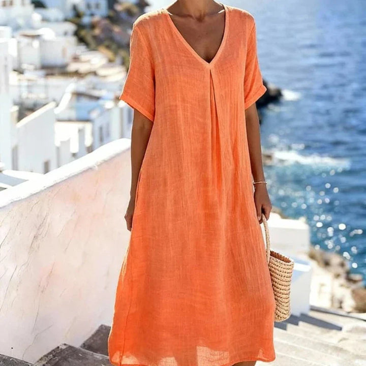 Women's relaxed fit v-neck midi dress with short sleeves, versatile for everyday casual looks.