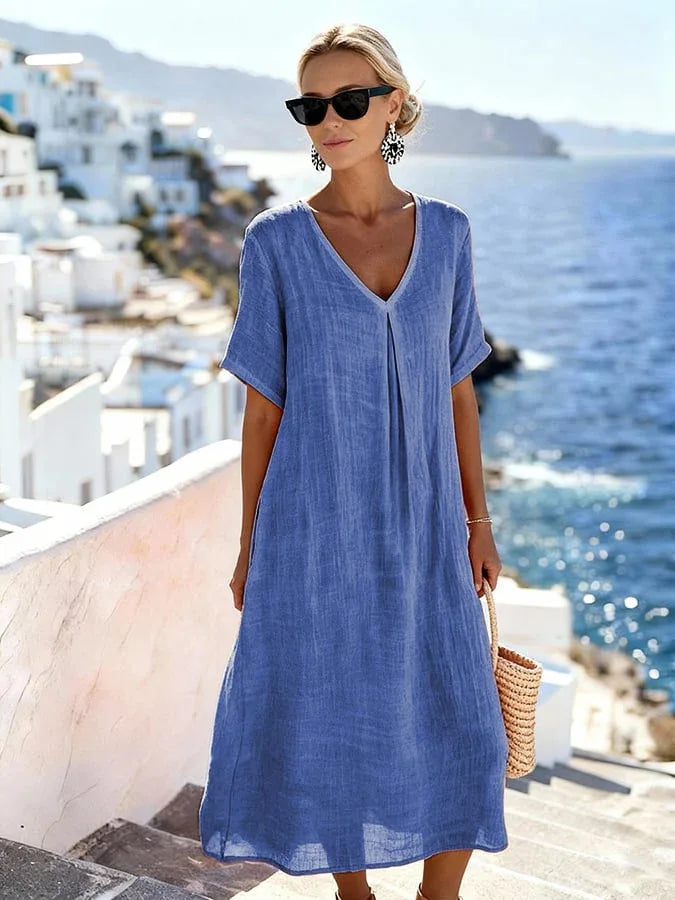 Model in relaxed v-neck midi dress with short sleeves, ideal for a summer beach walk or vacation.