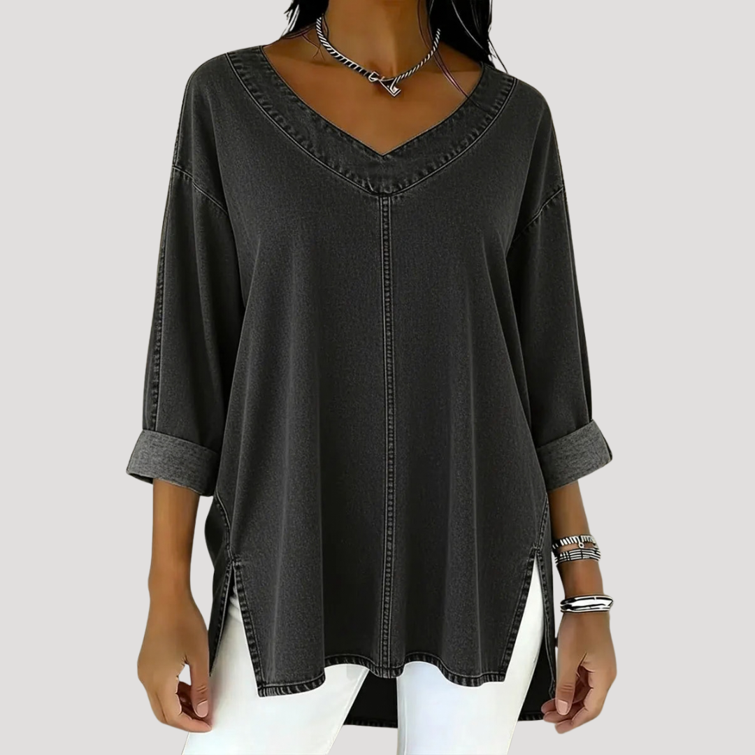 Blue women's relaxed fit tunic top. Features V-neck, elbow sleeves, and stylish side slits for comfort.