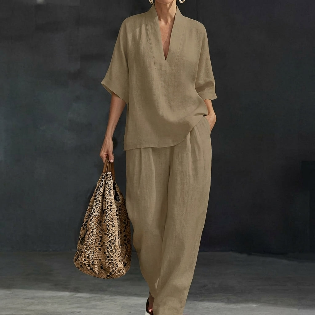 Model in a stylish relaxed fit womens two-piece set: V-neck top & wide-leg pants, for versatile wear.