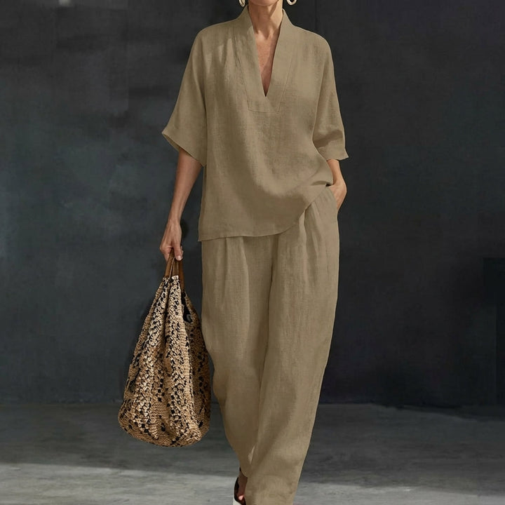 Model in a stylish relaxed fit womens two-piece set: V-neck top & wide-leg pants, for versatile wear.