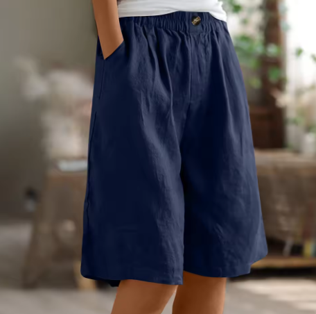 Model sitting comfortably in Renee women's elastic waist shorts, showing ease of movement.