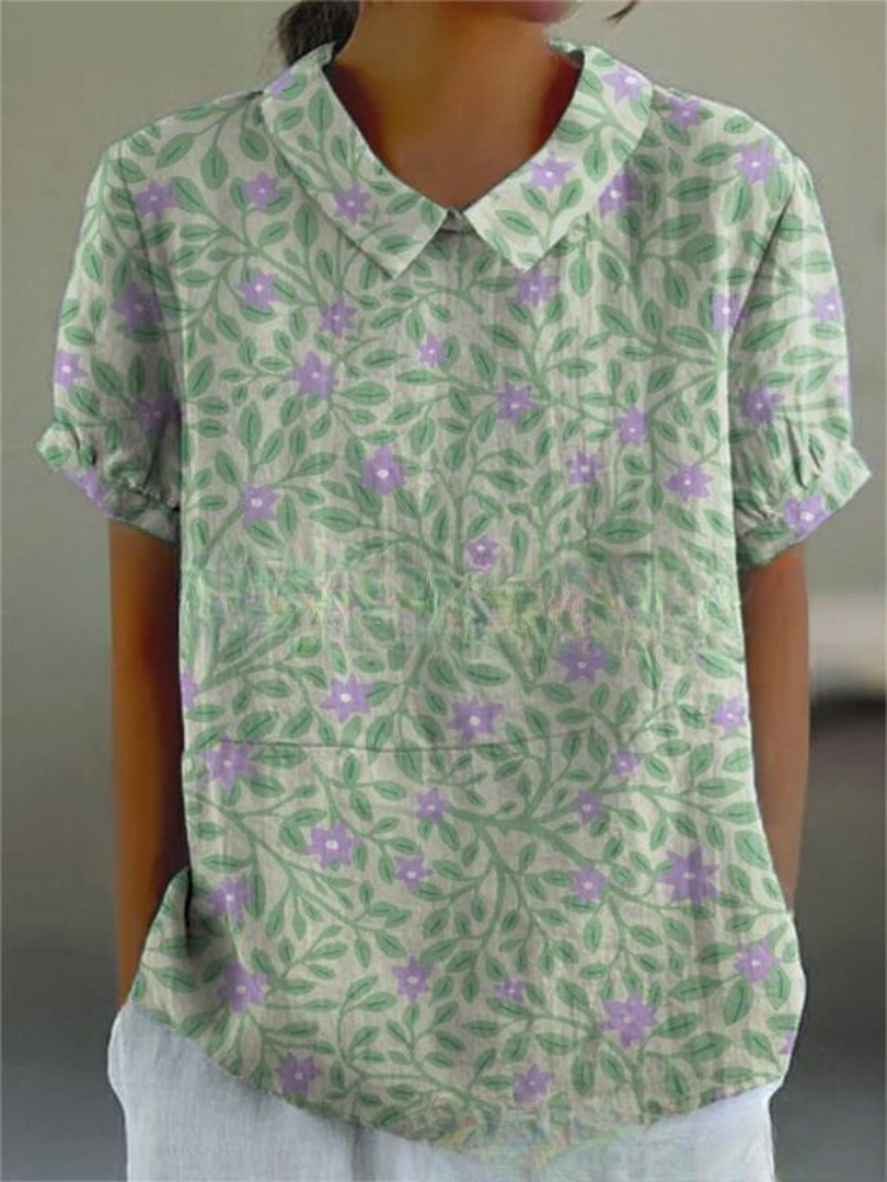 Casual chic women's embroidered blouse, short sleeves, featuring vibrant floral pattern.