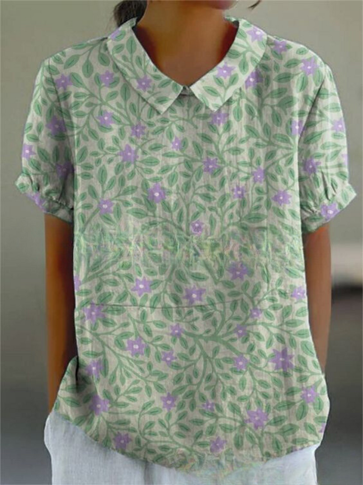 Casual chic women's embroidered blouse, short sleeves, featuring vibrant floral pattern.