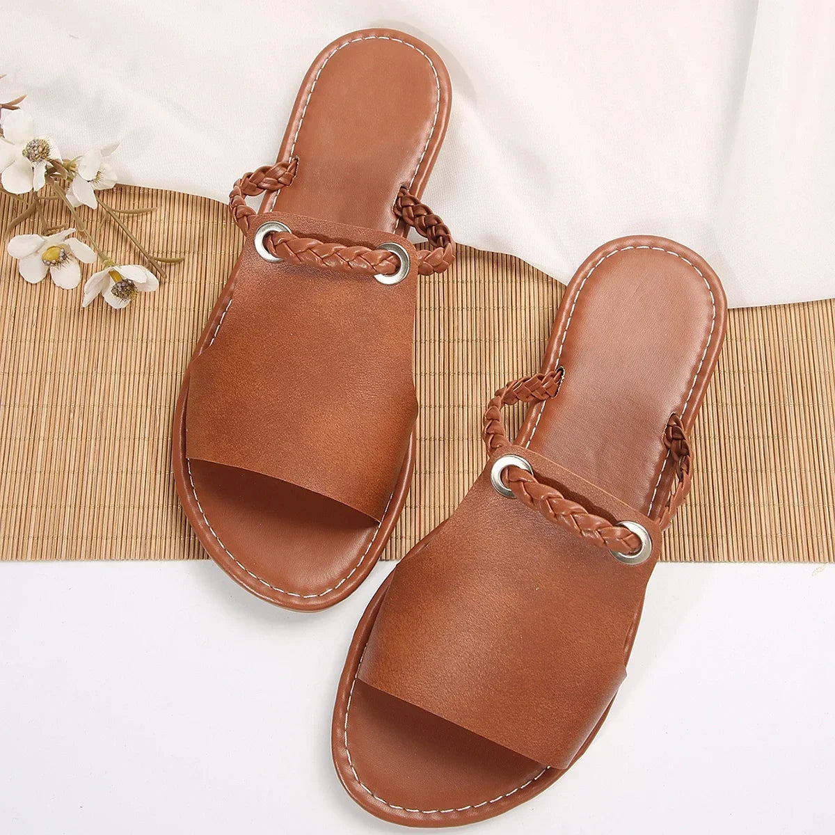 Summer-ready rich brown braided flat sandals for women, easy slip-on design.