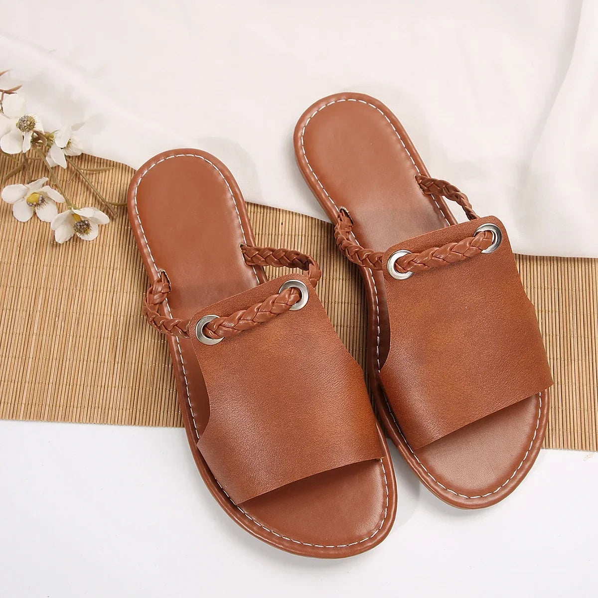 Women's comfortable black braided flat sandals, slip-on design for summer.