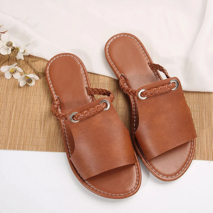 Women's comfortable black braided flat sandals, slip-on design for summer.