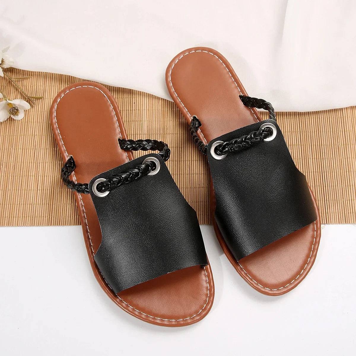 Summer comfort in women's rich brown braided slip-on flat sandals.