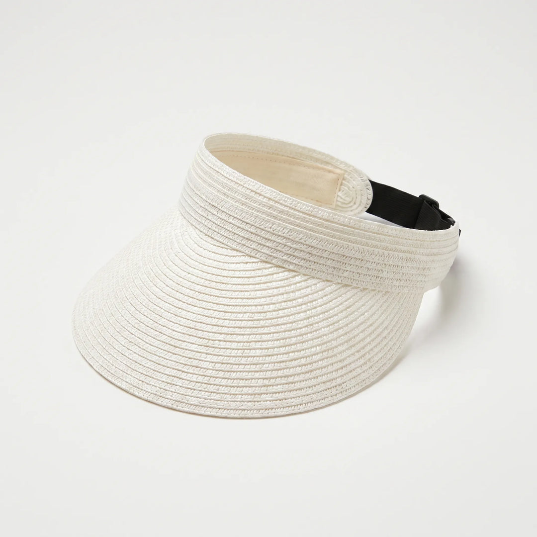 Woman wearing a black roll-up sun visor, enjoying the beach with wide brim sun protection.