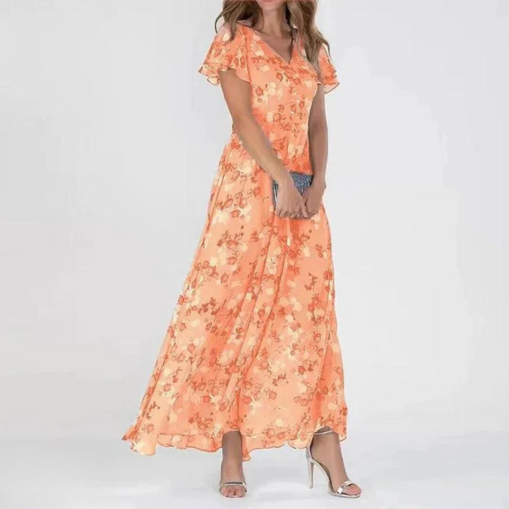 Chic women's romantic floral maxi dress. Features flutter sleeves & V-neck. Stylish summer party or vacation wear.