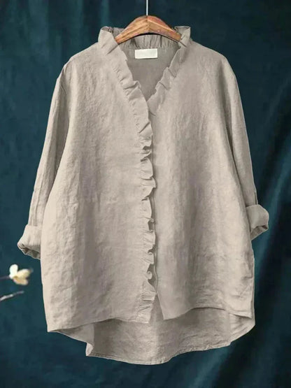 Chic women's oversized ruffle blouse, versatile for casual elegant everyday wear, feminine style.
