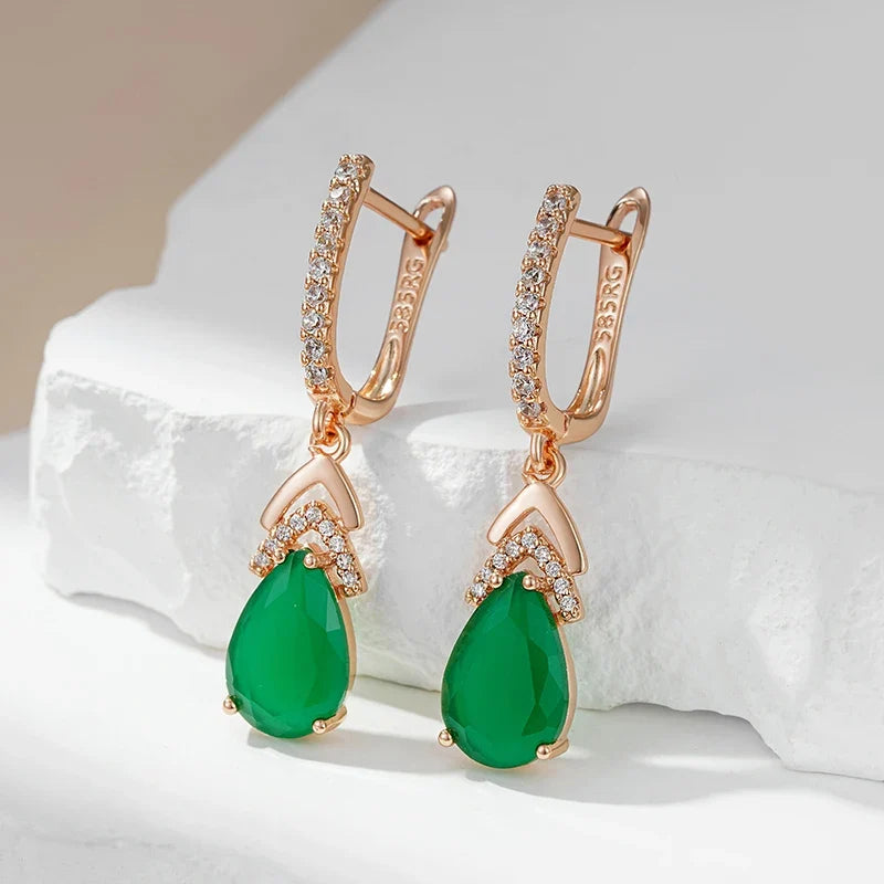 Sparkling rose gold pavé teardrop gemstone earrings for women. Elegant dangle jewelry with a luxurious look.