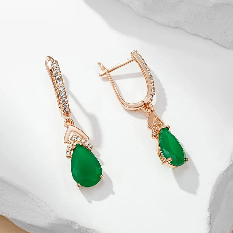 Close-up of women's rose gold pavé teardrop gemstone earrings, showcasing elegant sparkle.