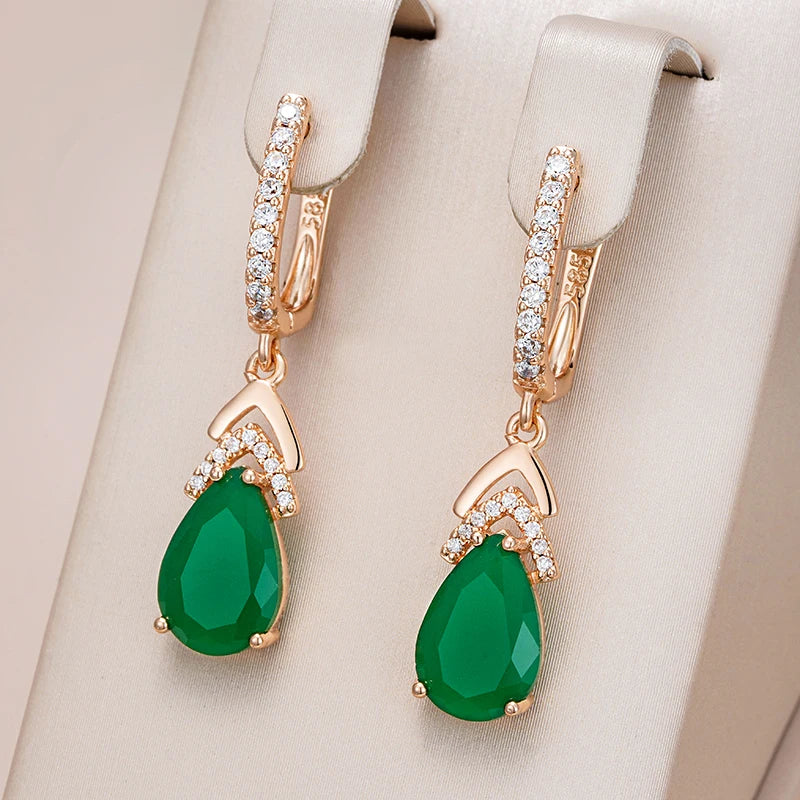 Rose gold women's earrings featuring pavé set teardrop gemstones, elegant and sparkling jewelry.