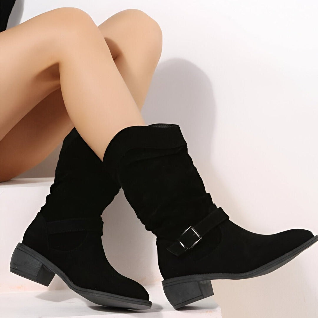 View of a pair of women's ruched ankle boots, highlighting the side zip closure and soft cushioned interior.