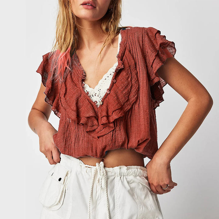 Women's ruffle front crop top, relaxed summer style with flutter sleeves.