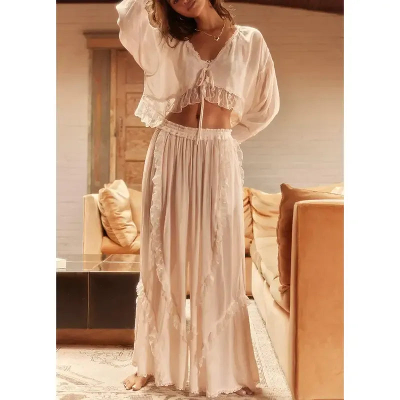 Stylish women's ruffle two-piece lounge set. Features a cropped top, wide-leg pants, and elastic waist for comfort.