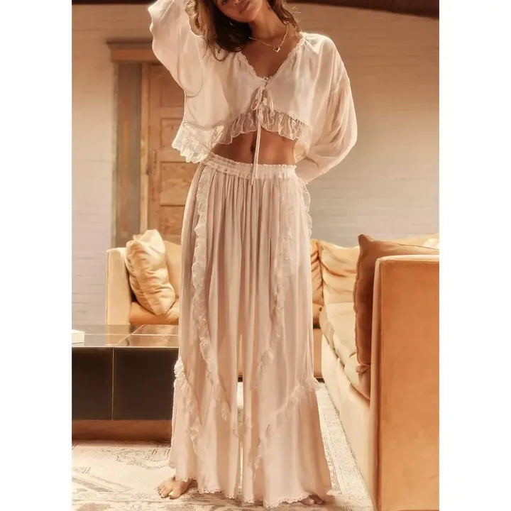 Stylish women's ruffle two-piece lounge set. Features a cropped top, wide-leg pants, and elastic waist for comfort.