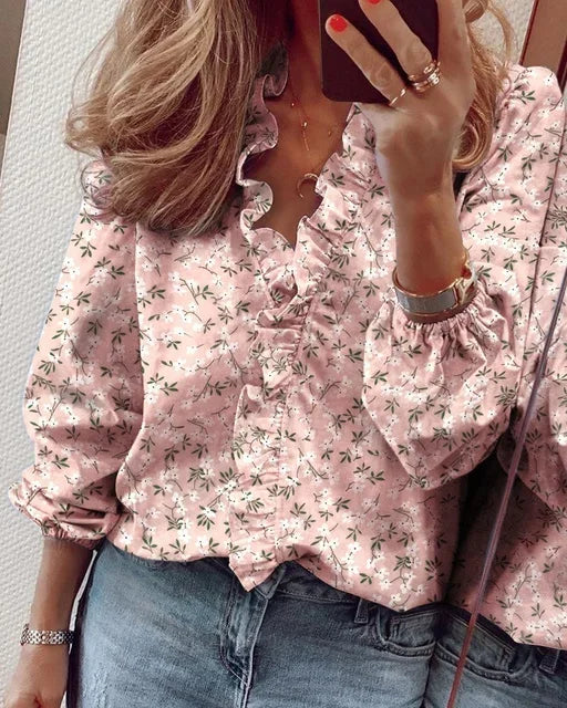 Stylish long sleeve women's blouse. Features a flattering ruffle V-neck and comfortable fabric for all-day wear.